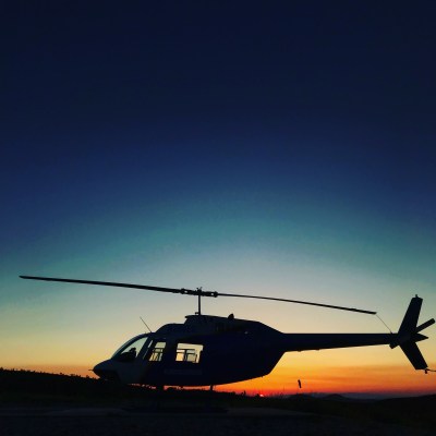 a Helicopter in front of a sunset